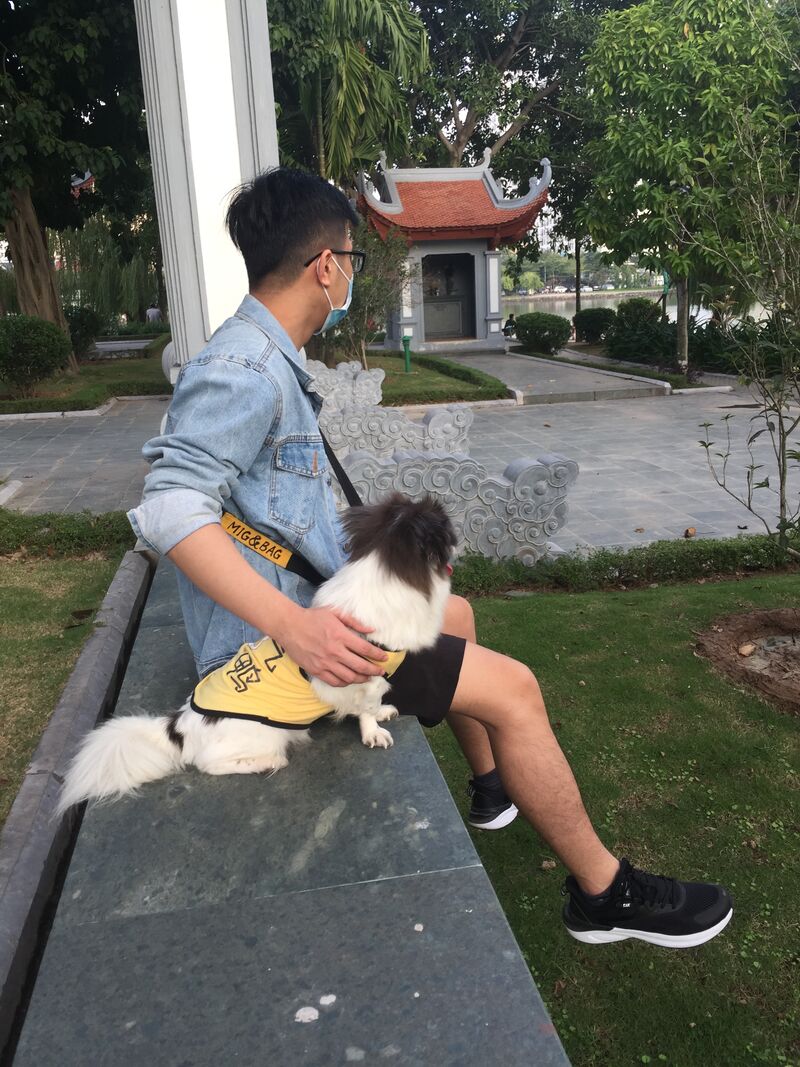J.Julian, the developer who builds SquishyFile, sitting on a park bench with a small dog